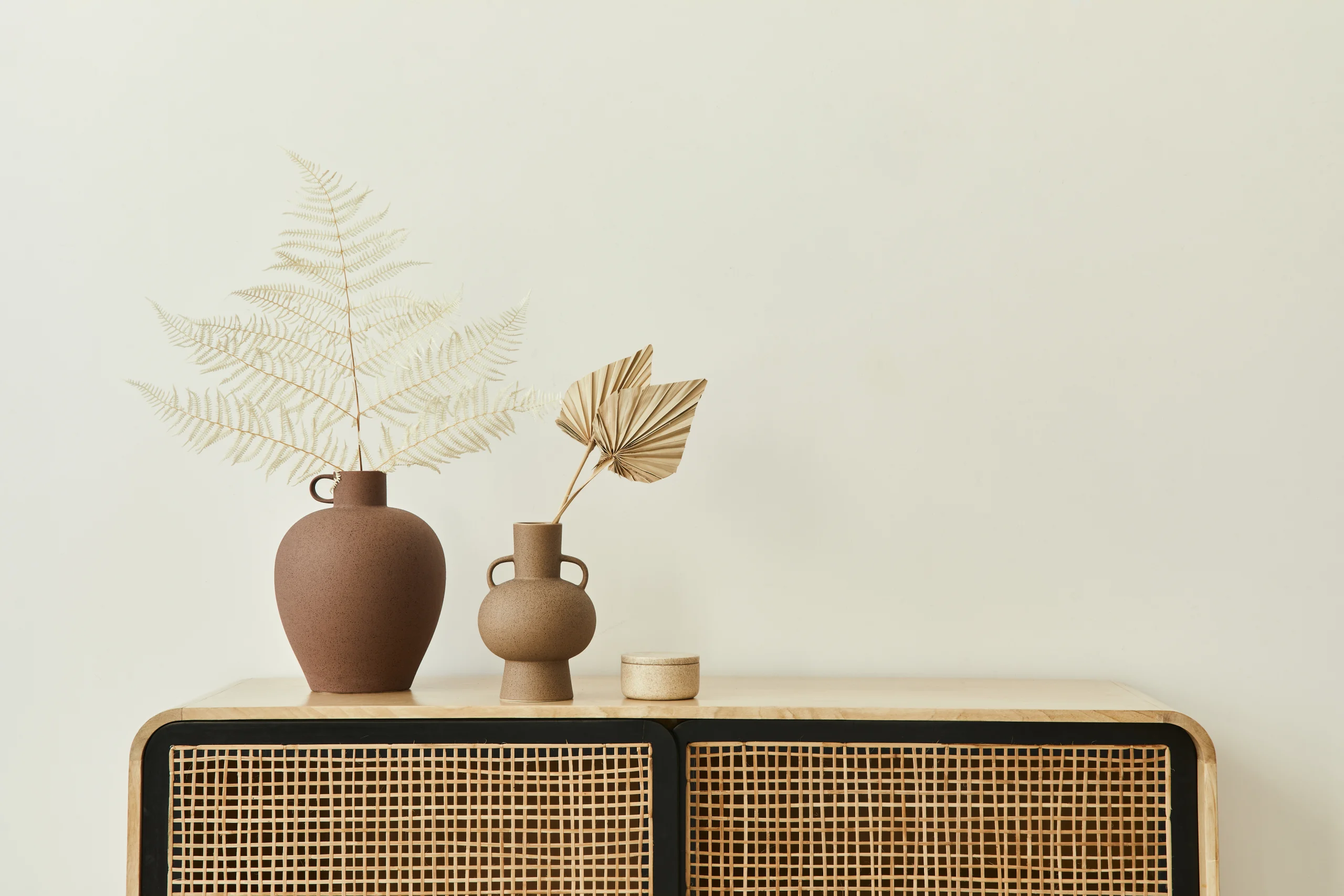 modern-scandinavian-home-interior-with-design-wooden-commode-dried-leafs-ceramic-vases-personal-accessories-stylish-home-decor-template-copy-space-white-walls